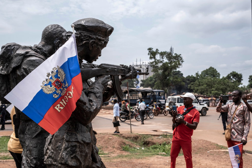 Russian flags in Bangui, Central African Republic, on 22 March, one of a number of African countries where Wagner Group is implicated in massacres, sexual violence, propaganda and propping up despotic regimes (Barbara Debout /AFP via Getty )