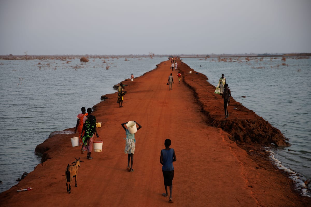 A dirt road reclaimed from floodwaters in November, Benitu, South Sudan (Luke Dray/Getty Images)