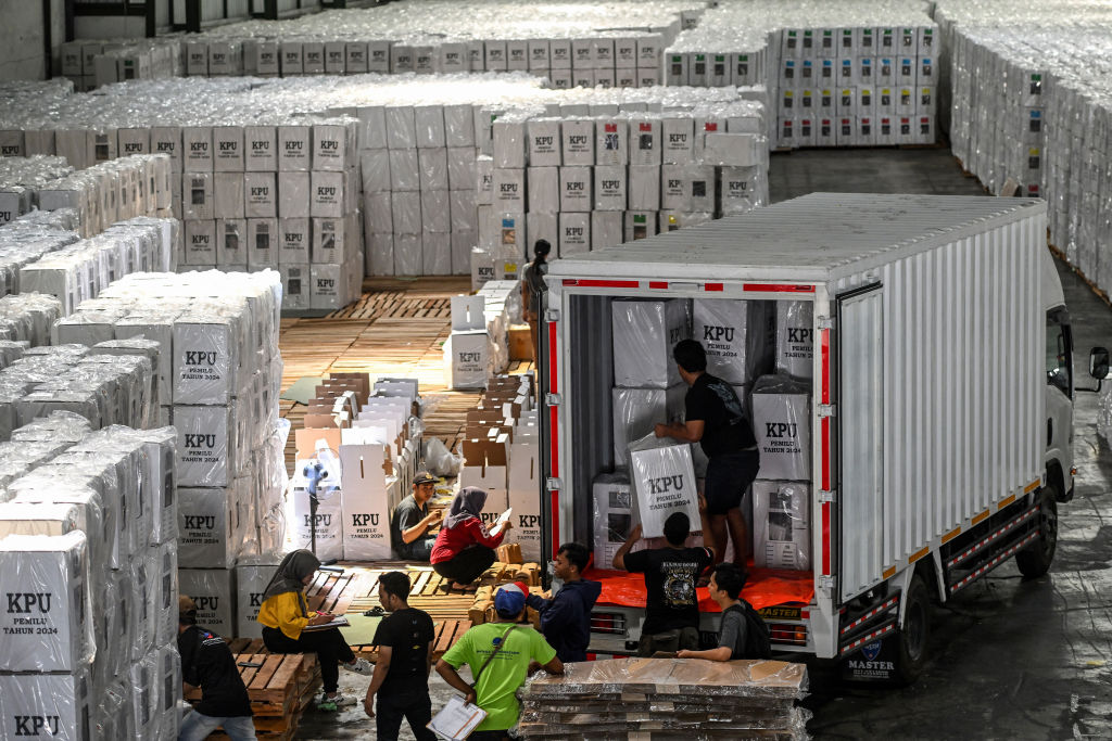 Workers load ballot boxes containing ballot papers onto a truck for distribution to sub-districts at a warehouse of the General Election Commission (KPU) in Surabaya, Java (Juni Kriswanto/AFP via Getty Images)