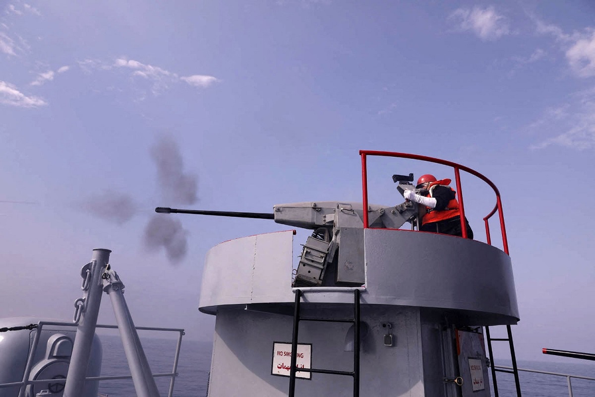 A handout picture made available by the Iranian Army official website on January, 21 2022 shows an navy-man firing atop a warship during a joint military drill in the Indian ocean. - Iran, Russia and China will began today joint naval drills for three days in the Indian Ocean, seeking to reinforce "common security", an Iranian naval official said. (Photo by Iranian Army office / AFP) (Photo by -/Iranian Army office/AFP via Getty Images)