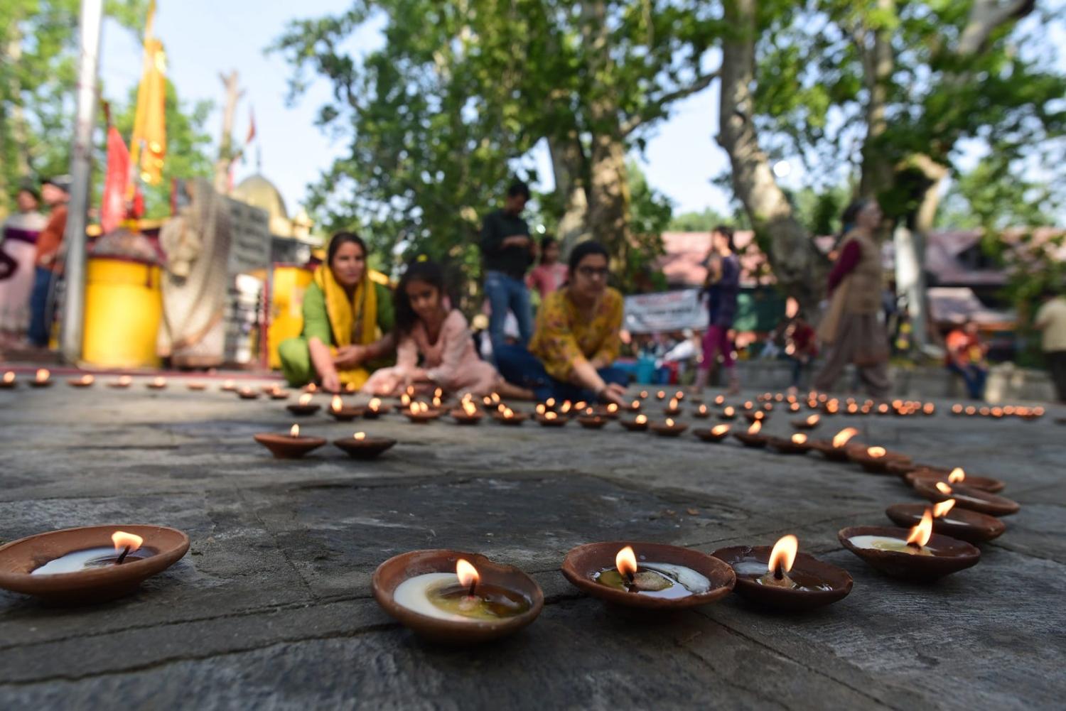 Kashmiri Pandit devotees light lamps for a Hindu religious festival at Tullamulla Ganderbal, 8 June 2022, in Srinagar, India (Waseem Andrabi/Hindustan Times via Getty Images)