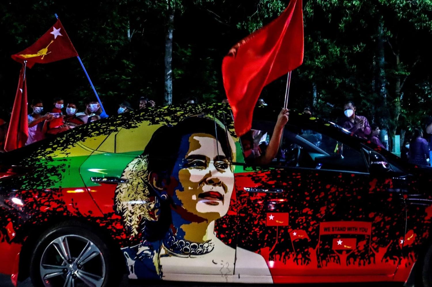 Supporters of the National League for Democracy party in Mandalay on 8 November 2020, as ballots for the parliamentary elections are counted (Ye Naing Ye/AFP via Getty Images)
