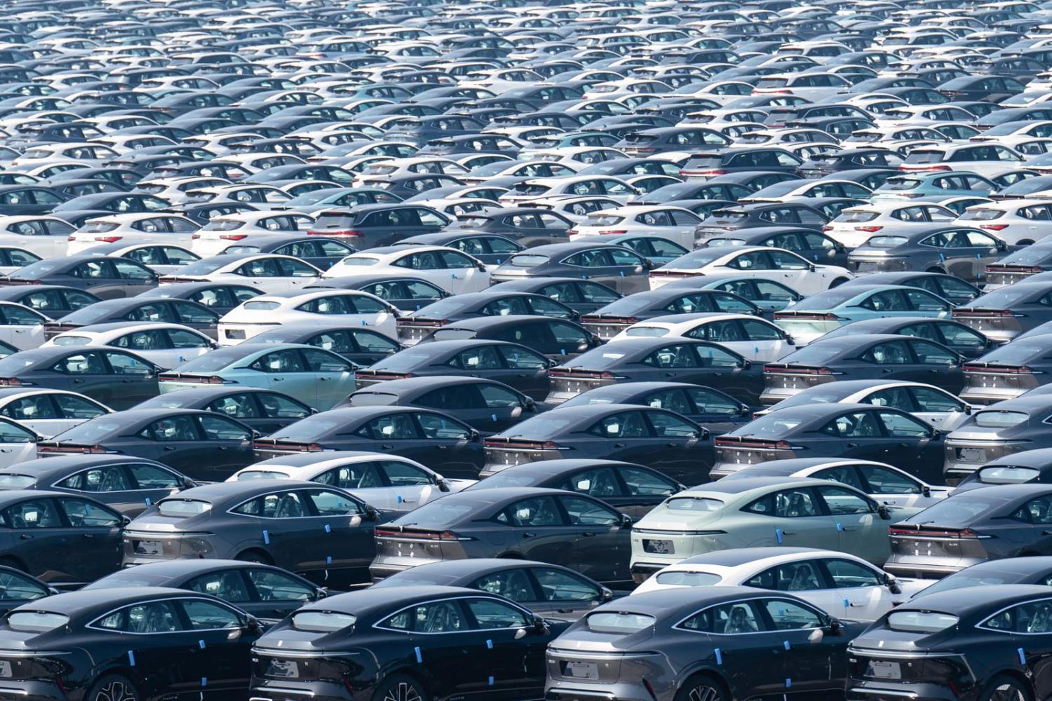 Newly produced electric vehicles parked at a distribution centre in China's southwestern Chongqing (STR/AFP via Getty Images)