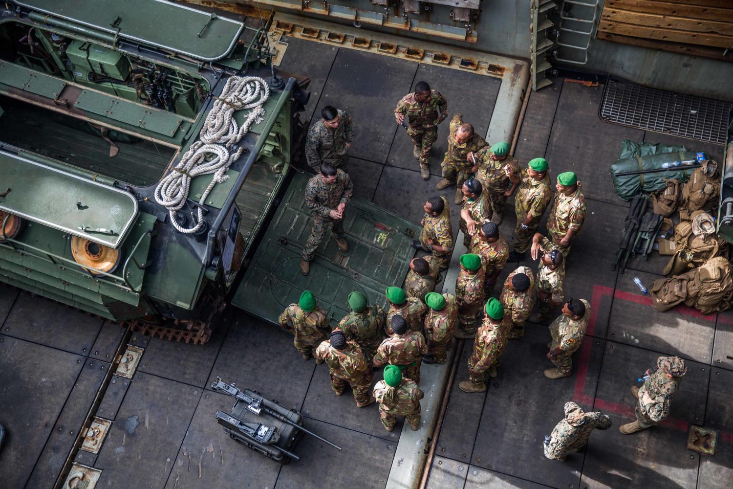 A US Marine introduces PNGDF service members to an amphibious assault vehicle (US Navy/Flickr)