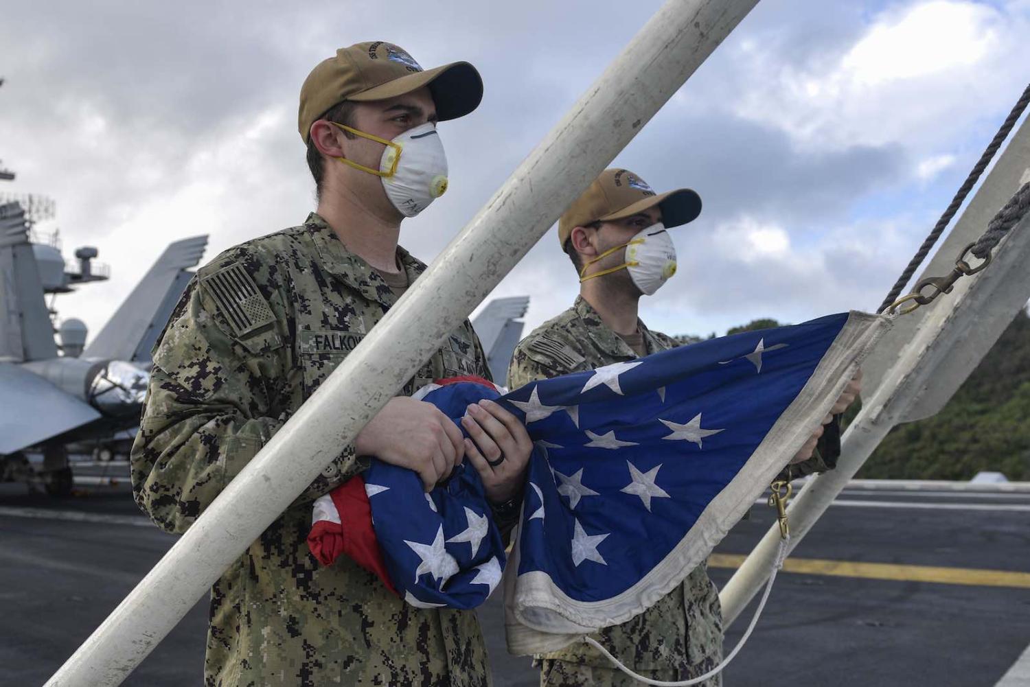T flight deck of the aircraft carrier USS Theodore Roosevelt while at port in Guam as crew are treated for Covid-19 (US Pacific Fleet/Flickr)