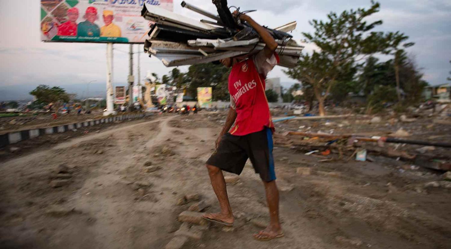 Collecting valuable material from a beach that was hit by a tsunami in Palu, Central Sulawesi on 29 September (Photo: Bay Ismoyo via Getty)