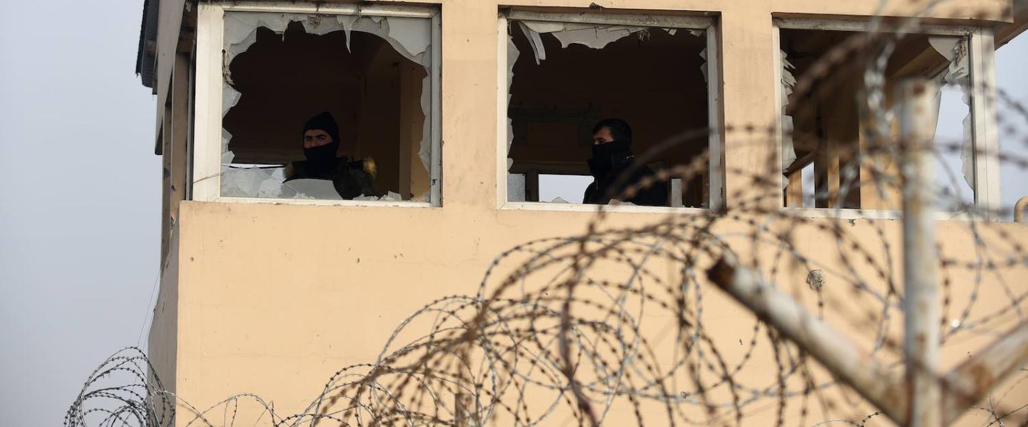 Private security guards in Kabul keep watch near the site of a 15 January attack claimed by the Taliban (Photo: Wakil Kohsar via Getty)