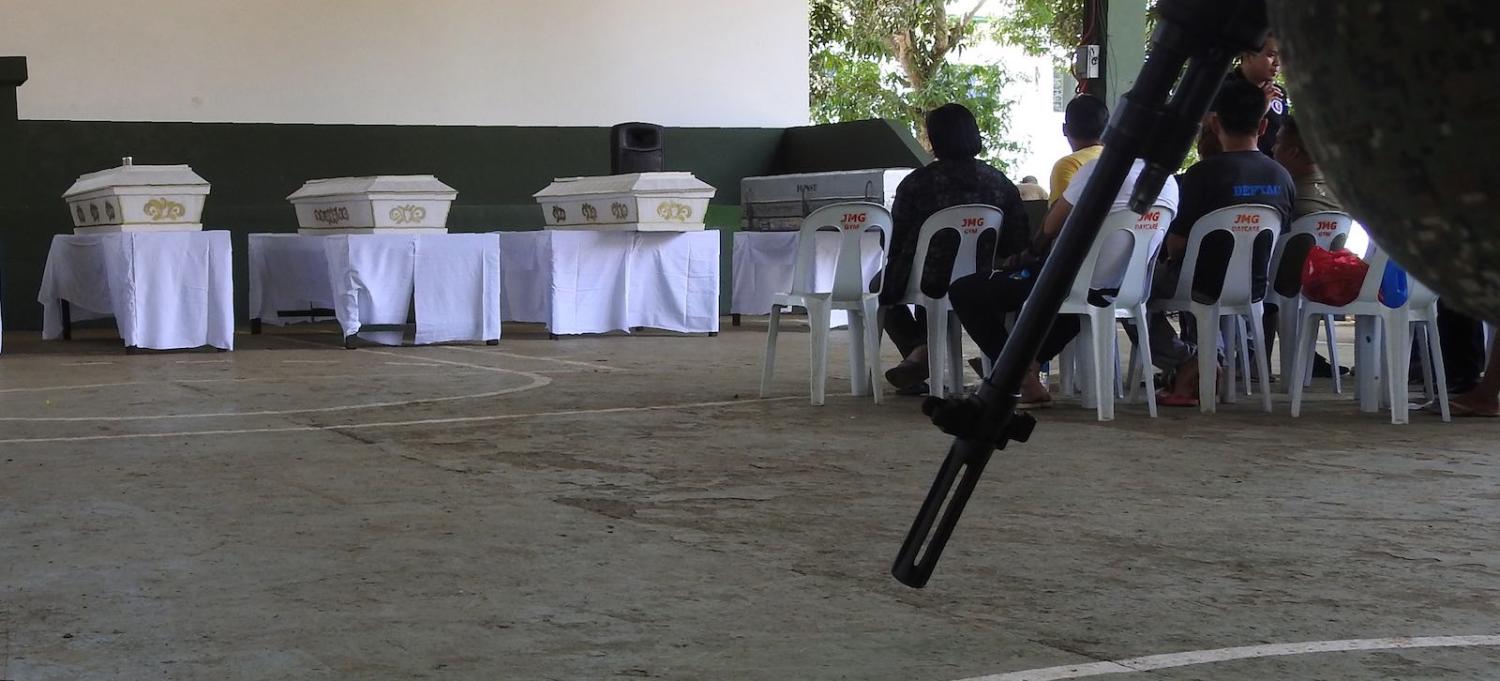 Soldiers stand guard near coffins containing the bodies of victims of the explosion inside a Jolo catholic cathedral on 27 January (Photo: Nickee Butlangan via Getty)