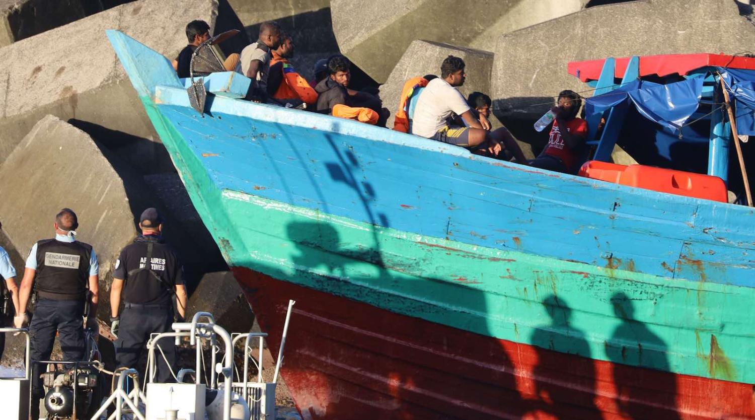 French gendarmes arrive to disembark migrants from a boat on 13 April in Sainte-Rose, on the French Indian ocean island of Réunion (Photo: Richard Bouhet/AFP/Getty Images)