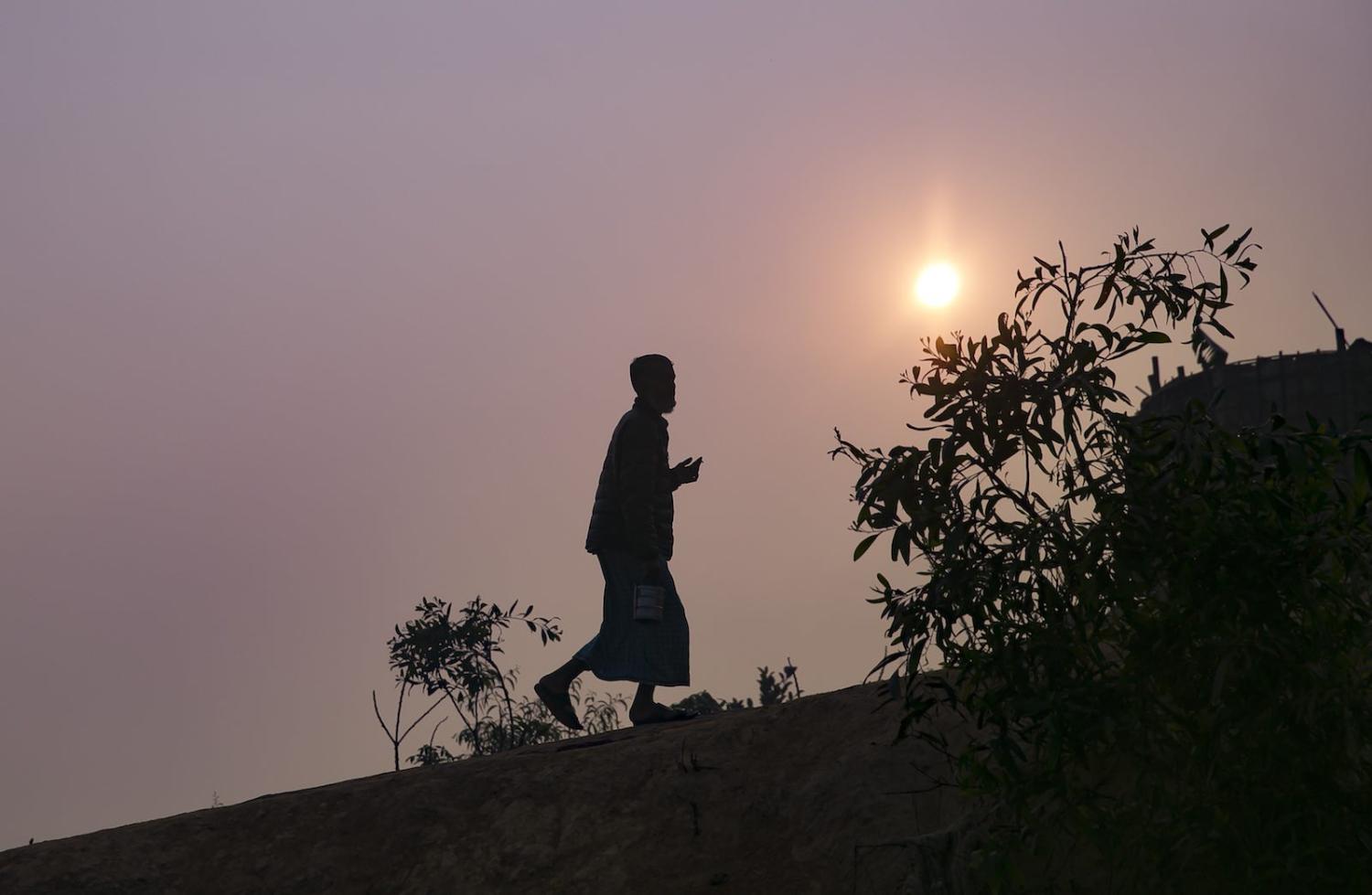 A Rohingya man walking in a refugee camp in Cox’s Bazar, Bangladesh, December 2019 (Photo: Allison Joyce/Getty Images)