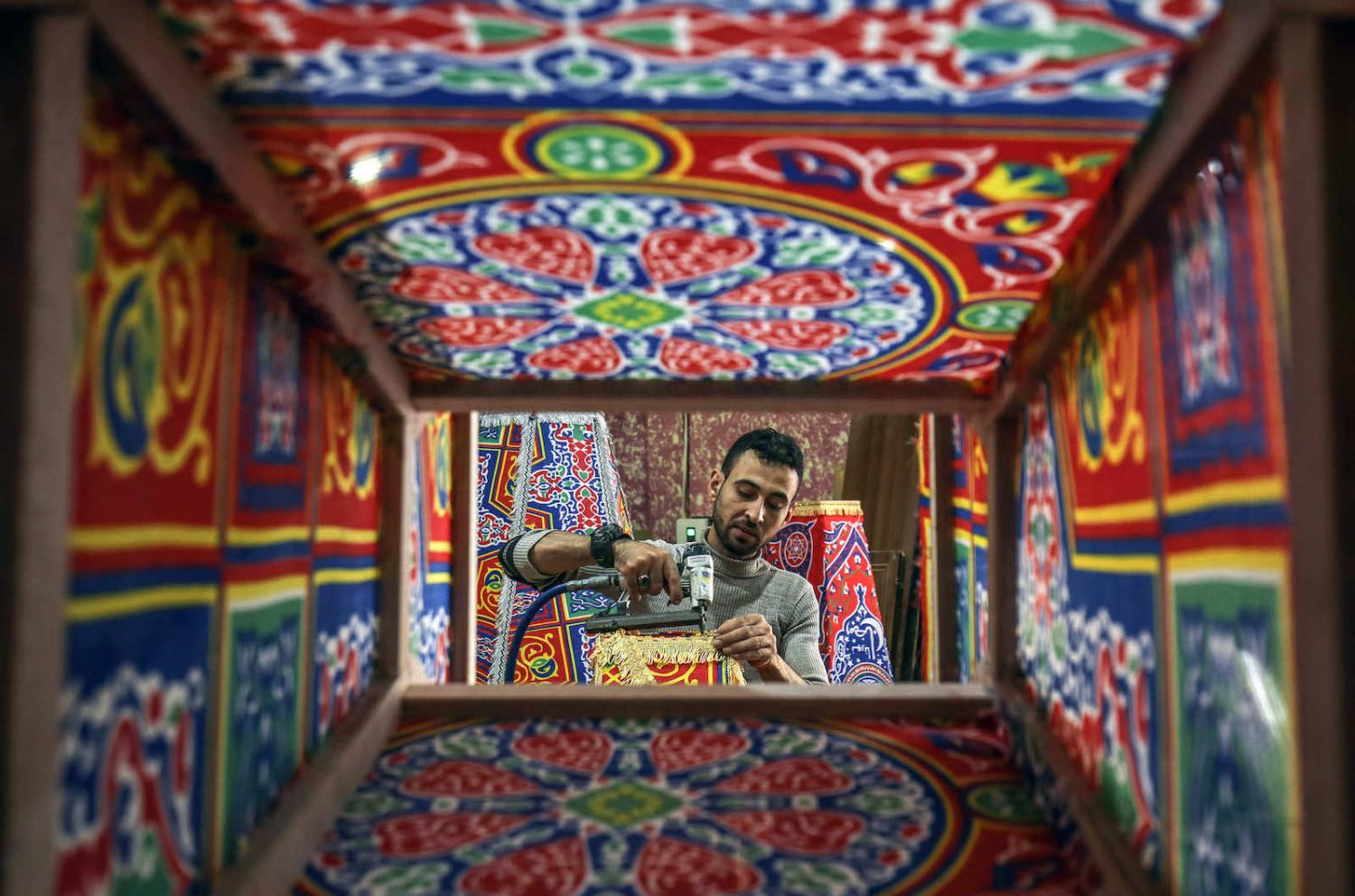 A craftsman fashions a “fanous” lantern used to celebrate the start of the Muslim holy month of Ramadan in a workshop in Khan Yunis in the southern Gaza Strip (Said Khatib/AFP via Getty Images)