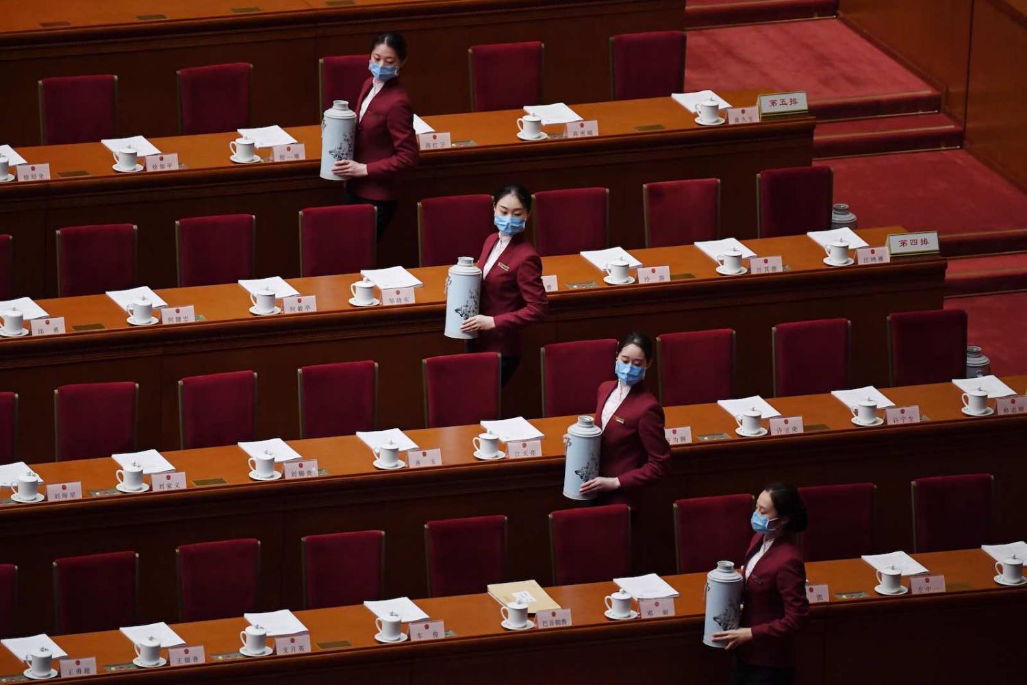 Attendants prepare to serve tea for delegates before the start of the second plenary session of the National People's Congress in the Great Hall of the People in Beijing in May (Photo by Noel Celis/AFP/Getty Images)