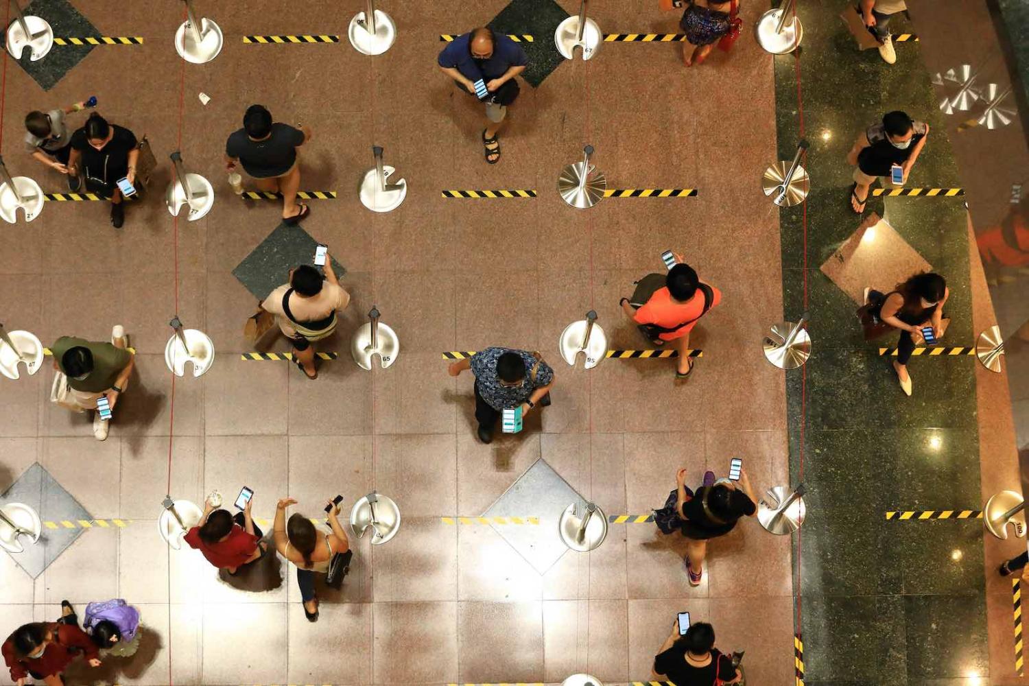 People queue to enter a shopping mall at Orchard Road in Singapore, June 2020 (Suhaimi Abdullah/Getty Images)