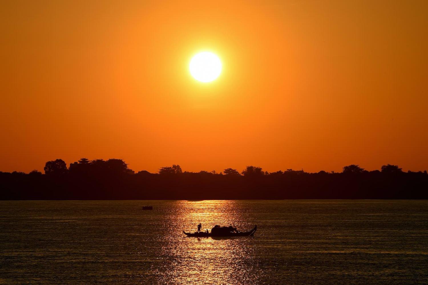 Fishing the Mekong River at sunrise in Phnom Penh, 26 August 2020 (Tang Chhin Sothy/AFP via Getty Images)
