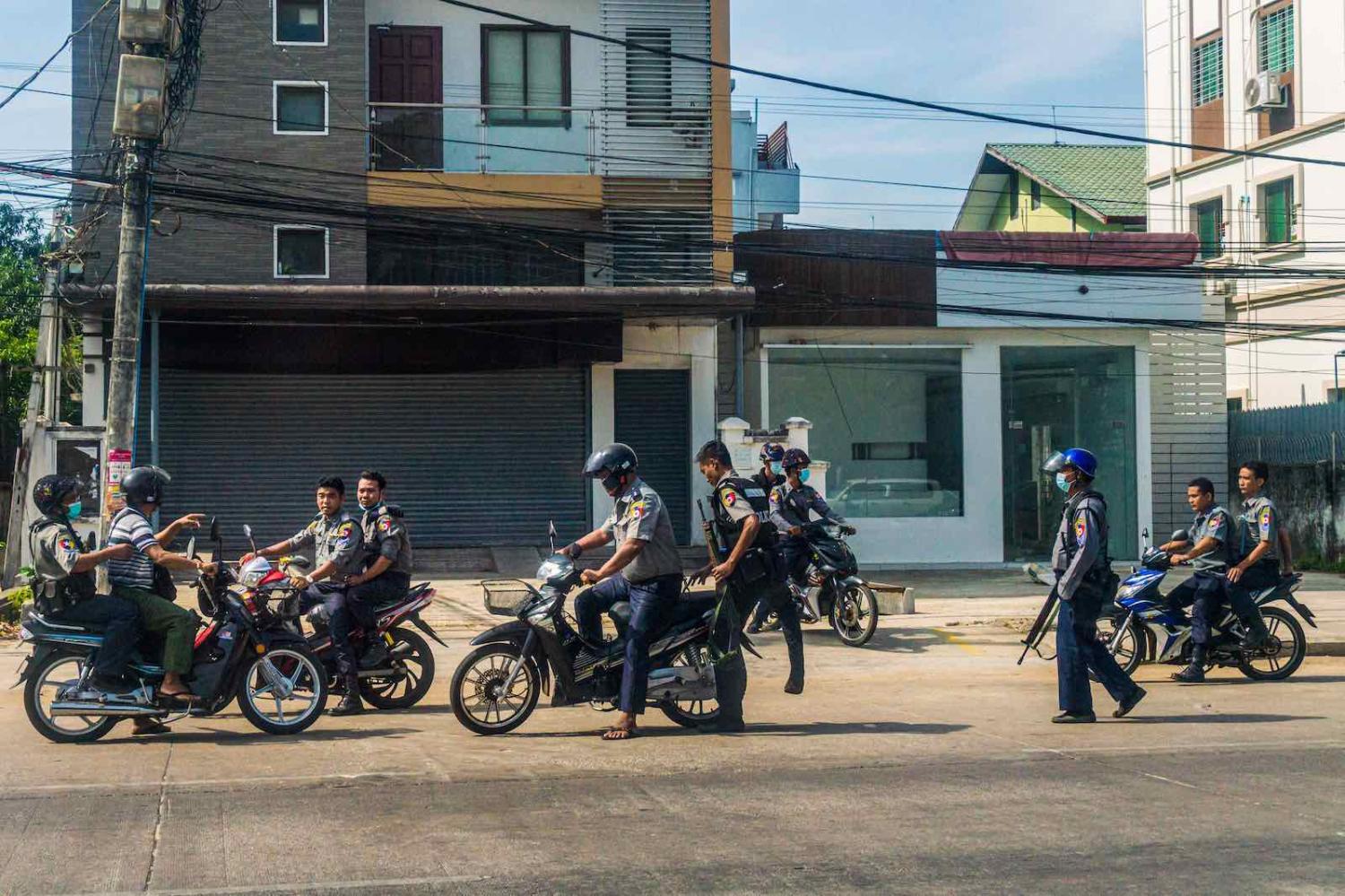 Police search for protesters who had been taking part in a demonstration against the military coup in Yangon, 15 May 2021 (STR/AFP via Getty Images)