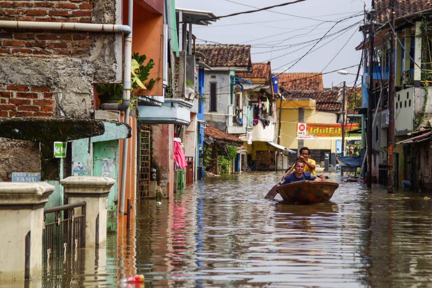 Flooding in Indonesia’s Bandung district from overflow of the Citarum River, which displaced nearly 60,000 people, 24 May 2021 (Algi Febri Sugita/NurPhoto via Getty Images)