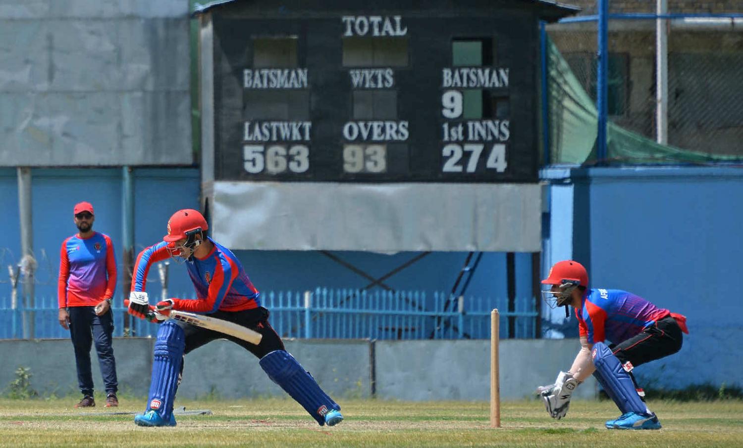 Afghanistan’s national cricket team players at a training session at the Kabul International Cricket Ground in Kabul on 21 August (Hoshang Hashimi/AFP via Getty Images)