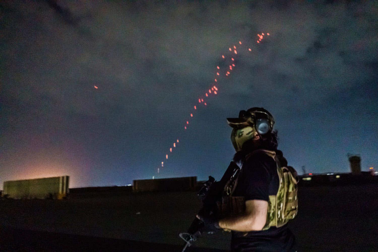 A Taliban fighter wielding American weapons and equipment during the takeover of Kabul International Airport on 31 August (Marcus Yam/ Los Angeles Times via Getty Images)