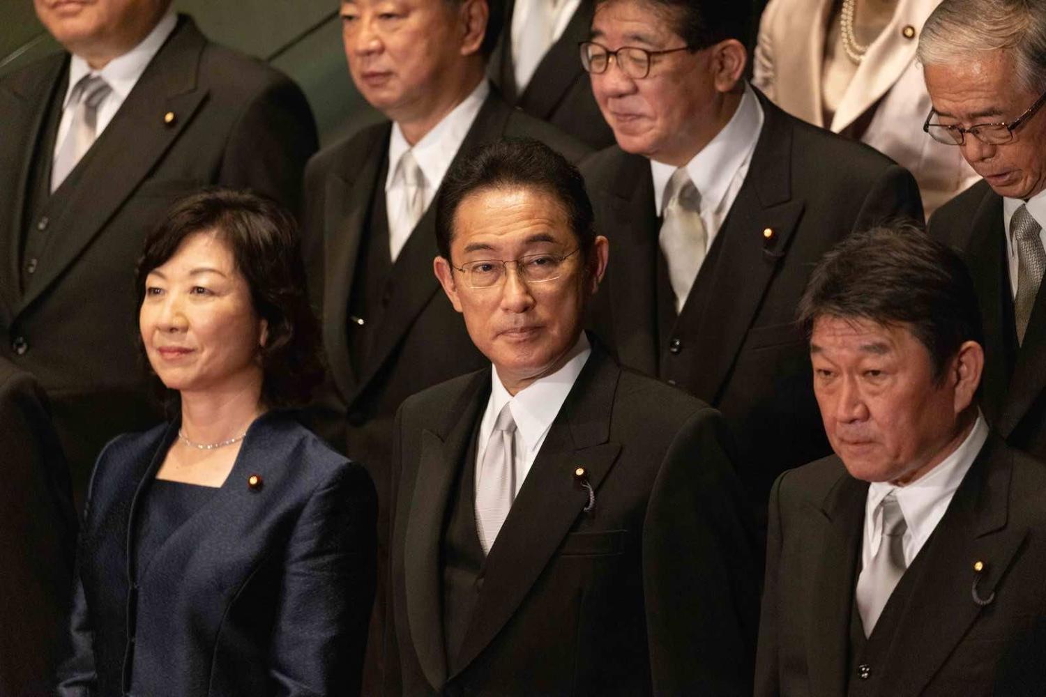 Japan’s newly elected Prime Minister Fumio Kishida (centre) with his cabinet members at the prime minister’s official residence in Tokyo on 4 October (Stanislav Kogiku/Anadolu Agency via Getty Images)
