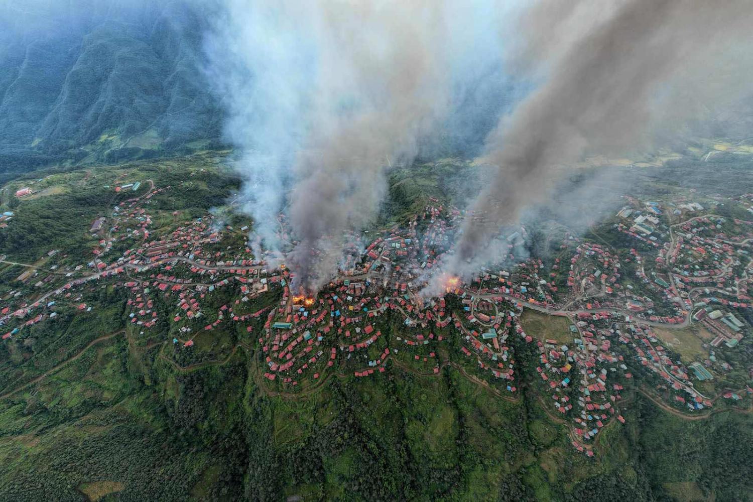 Smoke and fires on 29 October 2021 at Thantlang, Chin State, Myanmar,  where more than 160 buildings have been destroyed caused by shelling from junta troops, according to local media (STR/AFP via Getty Images)