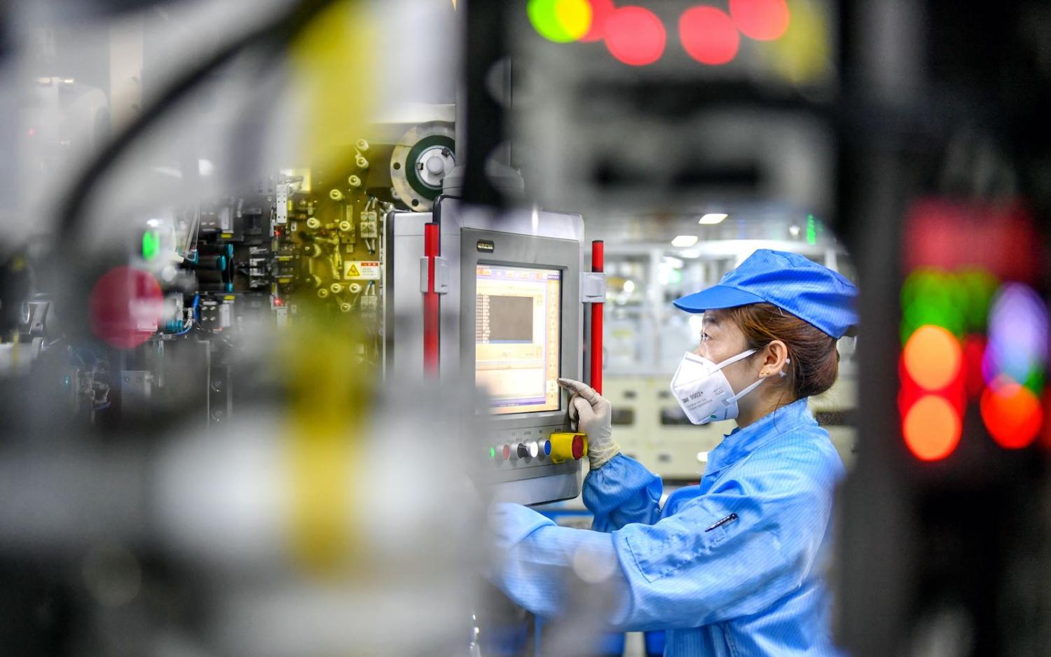 A worker on the lithium battery production line at a factory in Changxing County, Zhejiang Province of China. (Tan Yunfeng/VCG via Getty Images)