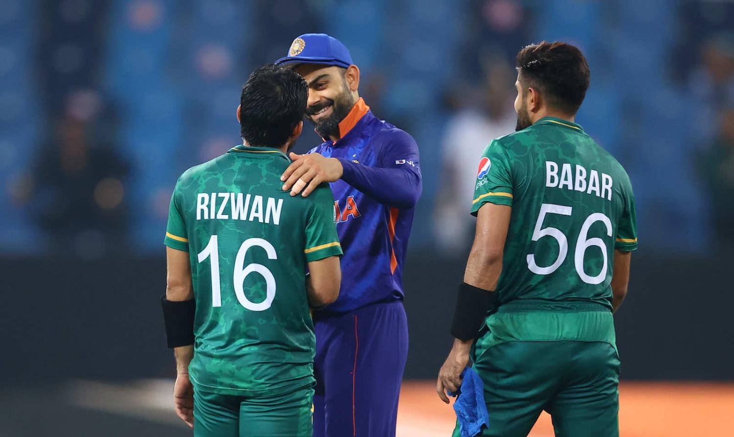 Mohammad Rizwan and Babar Azam of Pakistan with Virat Kohli of India following the ICC Men’s Twenty20 World Cup match between India and Pakistan at Dubai International Stadium on 24 October 2021 (Michael Steele-ICC/ICC via Getty Images)
