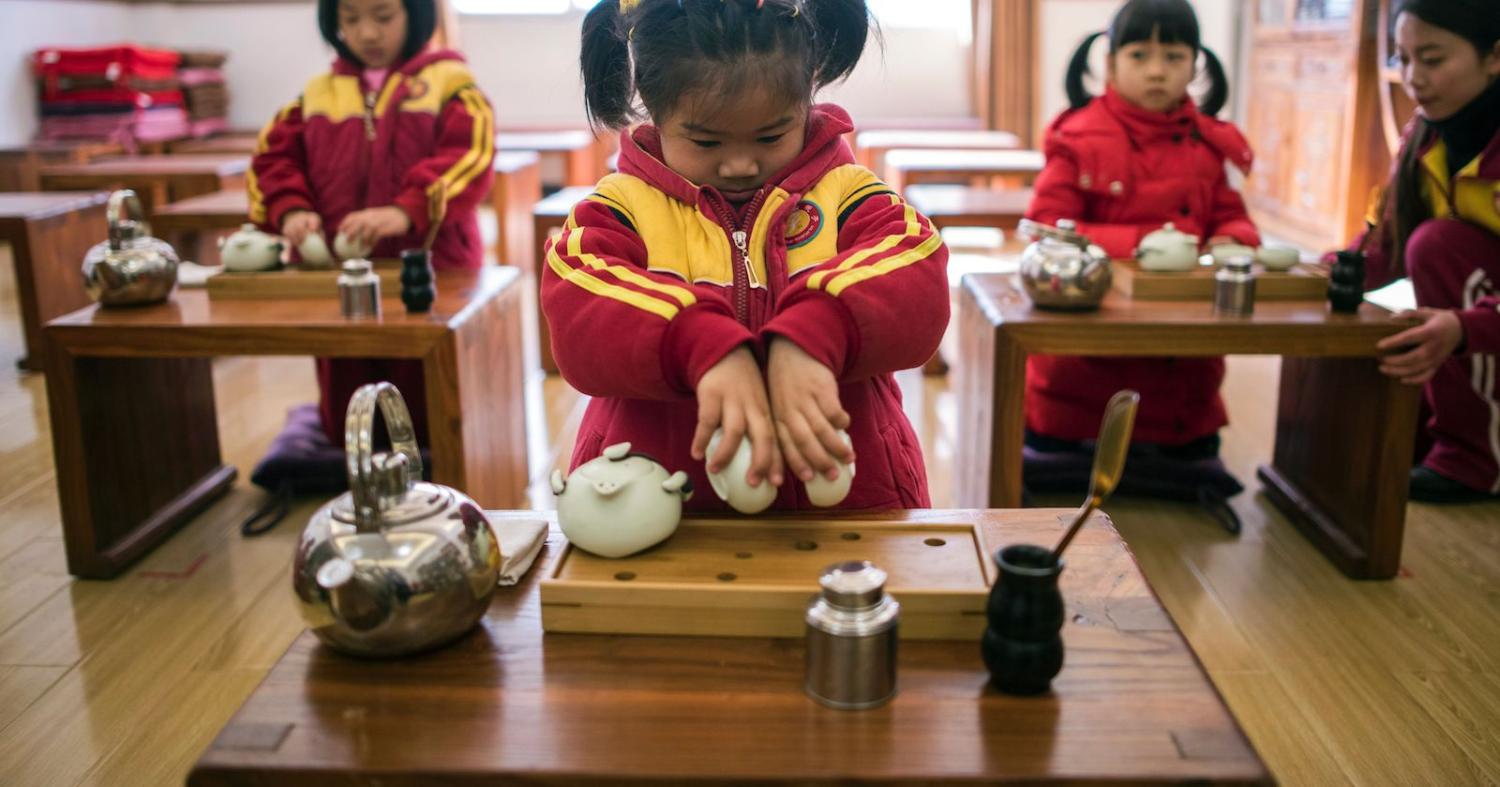 Girls learning to perform a tea ceremony in kindergarten. (Photo: Johannes Eisele via Getty)