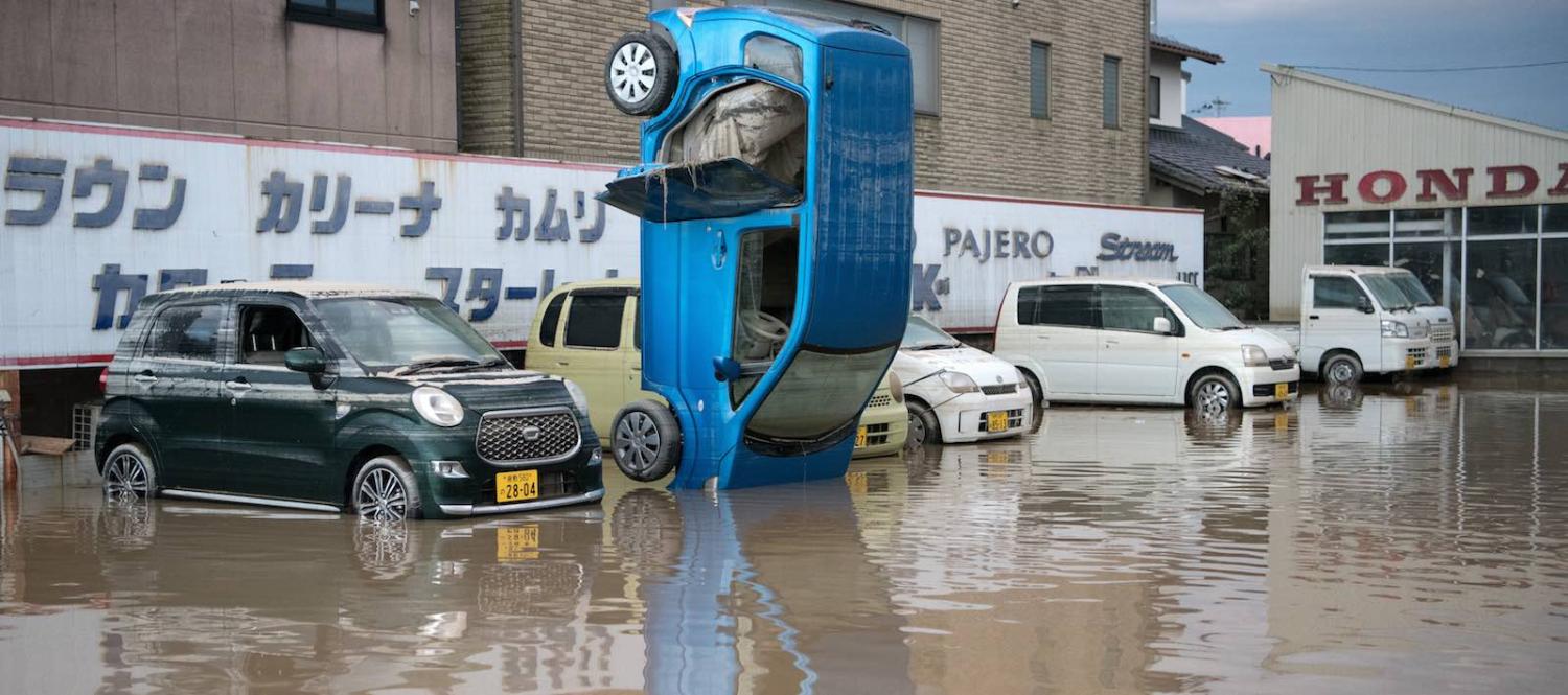 A car stands on its front following heavy flooding on 8 July in Kurashiki near Okayama, Japan (Photo: Carl Court/Getty)