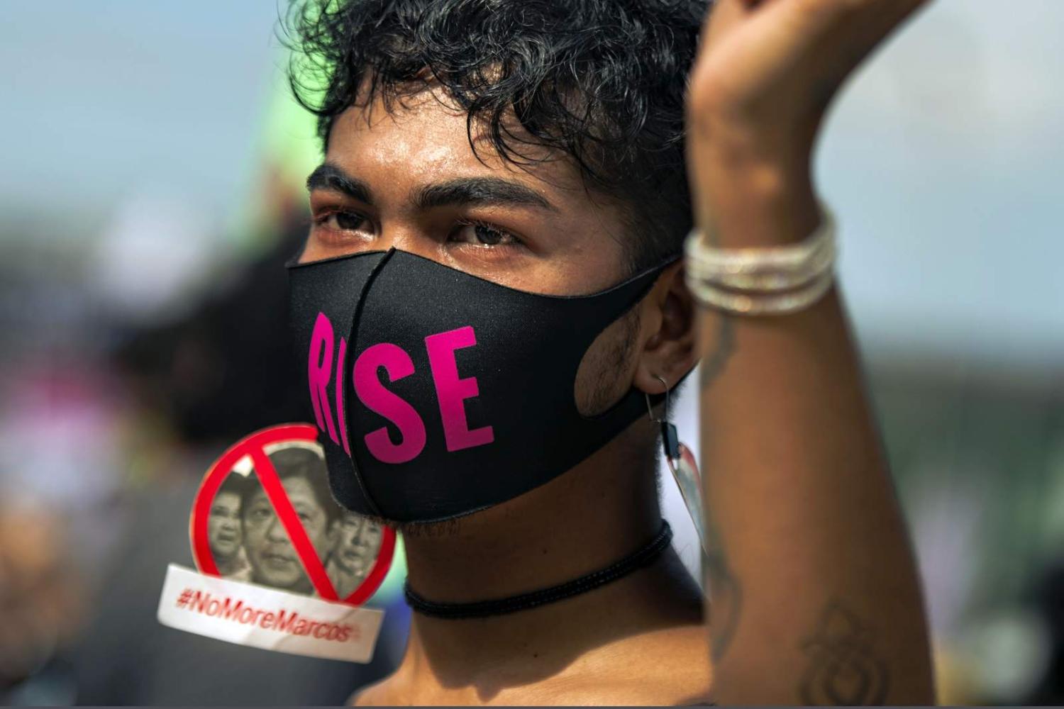 Protesters march to the People Power Monument to commemorate the 36th anniversary of People Power that ousted dictator Ferdinand Marcos, 25 February 2022, Manila, Philippines (Jes Aznar/Getty Images)