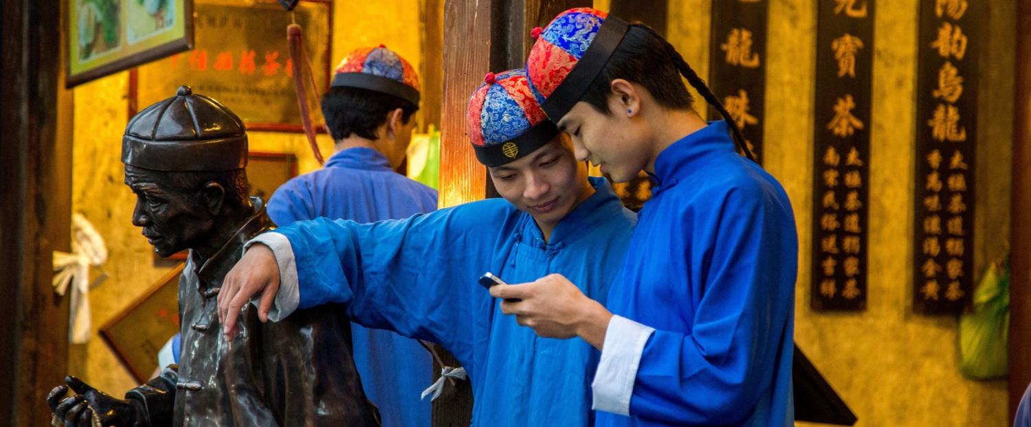 Two tea-shop waiters in Hangzhou, dressed in traditional costume. (Photo by Zhang Peng/ Getty Images)