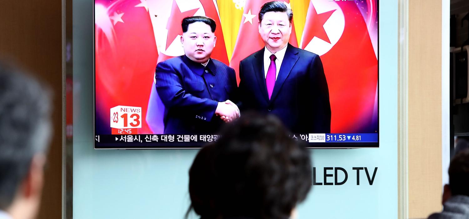 South Koreans watch a broadcast of North Korean leader Kim Jong-un meeting Chinese President Xi Jinping. (Photo: Chung Sung-Jun/Getty Images)