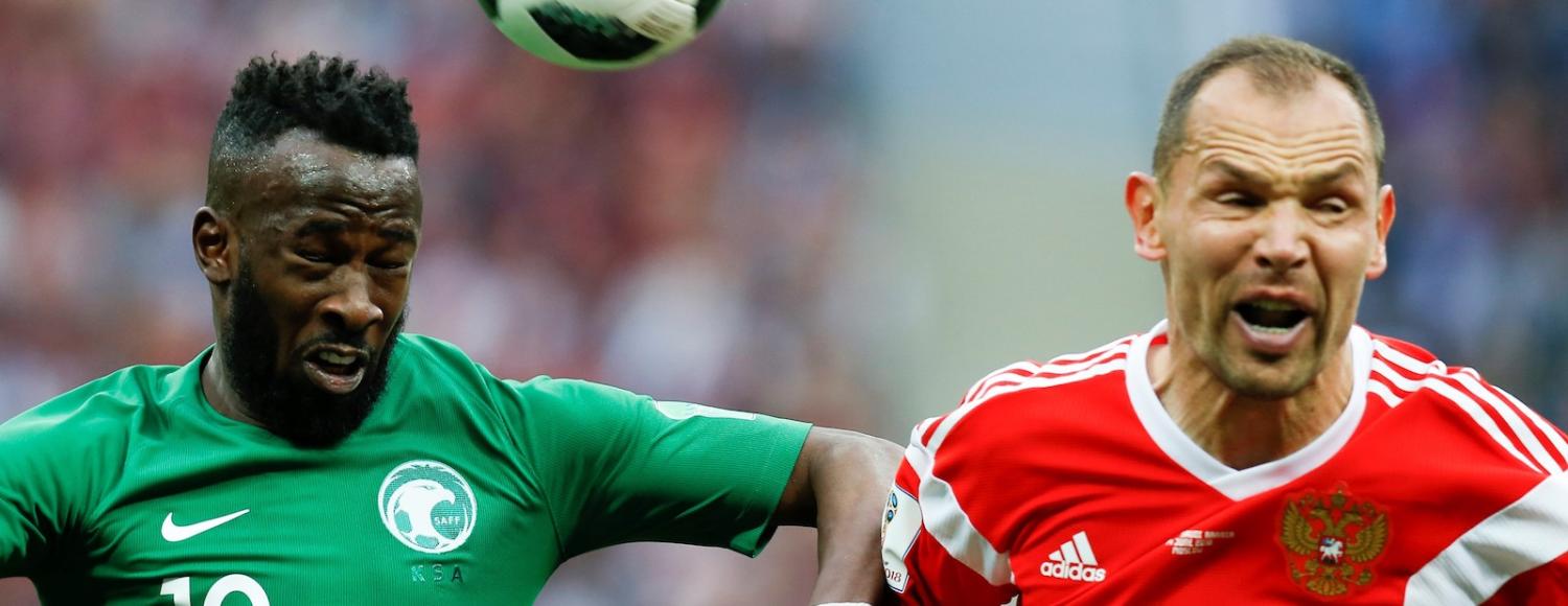 Sergei Ignashevich of Russia vies with Fahad Al-Muwallad of Saudi Arabia (Photo: Sefa Karacan/Getty)