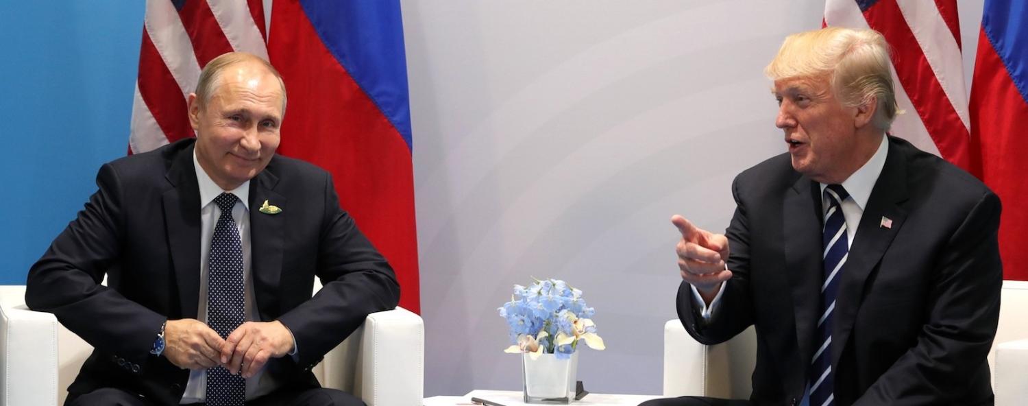 Russian President Vladimir Putin and US President Donald Trump speak during the G20 summit in Hamburg, July 2017 (Photo: Anadolu Agency/Getty)
